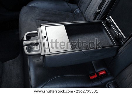 Luxury car central opened armrest for rear seat passengers with cup holders. Rear passenger armrest. Leather passenger seats with armrest. Royalty-Free Stock Photo #2362793331