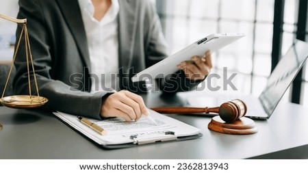 justice and law concept. Male judge in a courtroom the gavel, working with smart phone and laptop and digital tablet computer on white table 
