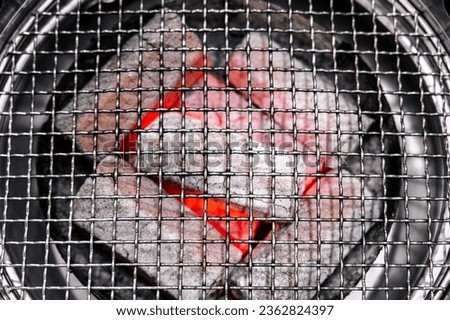 Barbecue grid stove grill burning red hot charcoal