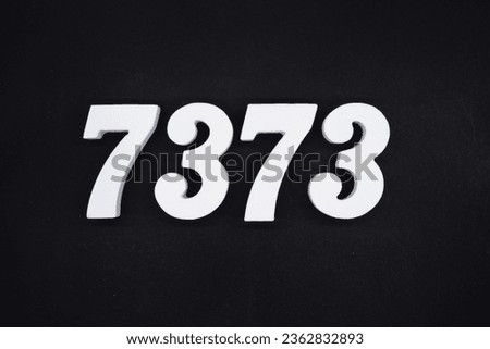 Black for the background. The number 7373 is made of white painted wood.