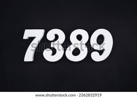 Black for the background. The number 7389 is made of white painted wood.