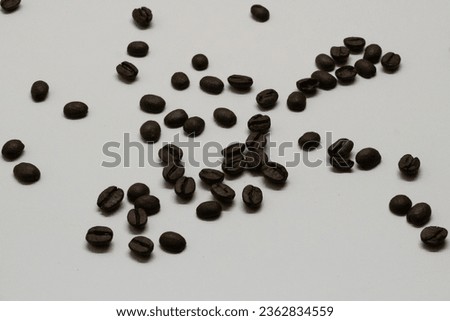 An exquisite display of coffee beans in all their glory, set against a pure white background. This visually appealing stock photo is a must-have for coffee brands, blogs, and menus.