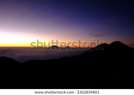 The beautiful of mountain landscape with fog and forest. sunrise and sunset in mountains. Mountain range with visible silhouettes through the morning colorful fog. 