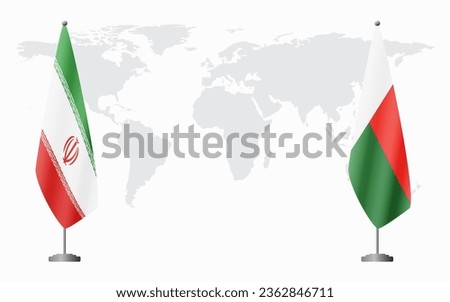 Iran and Madagascar flags for official meeting against background of world map.