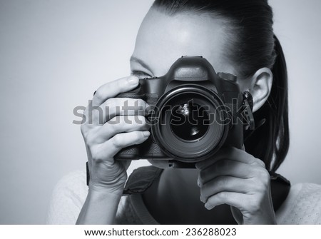 Young woman using professional camera