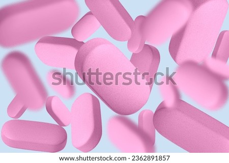 Pink capsules, pills and tablets. On
blue background.