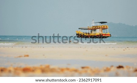 Travel to the seaside on holiday with a boat in the middle of the sea.