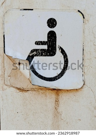 handicapped sign on the wall of a house, closeup of photo