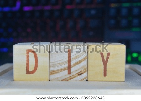 Photo of words with wooden block objects arranged into the word "DIY" in English