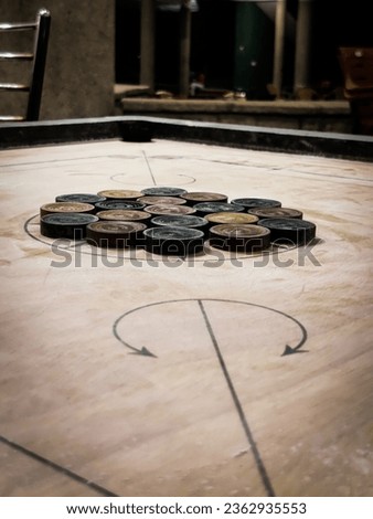 Wooden carrom board with wooden carrom coins