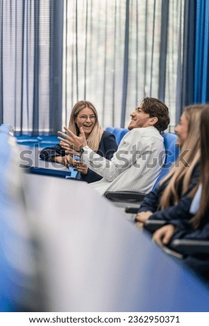 Overjoyed students laughing while attending classes. Royalty-Free Stock Photo #2362950371