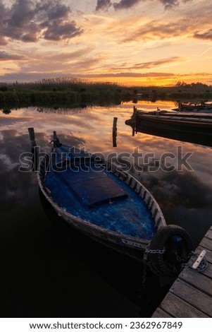 boats moored at the jetty at sunset