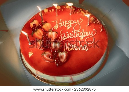 Cake with candles and the inscription "Happy Birthday Masha"