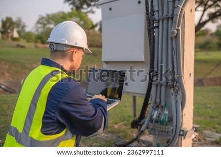 Telecommunication engineers work at cell towers for 5G cell phone signals,Network tower maintenance technicians Royalty-Free Stock Photo #2362997111