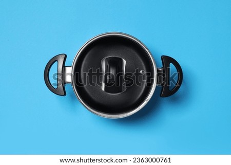 Empty pot with glass lid on light blue background, top view Royalty-Free Stock Photo #2363000761