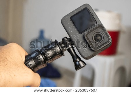 A Man Holding an Action Camera for Adventure Royalty-Free Stock Photo #2363037607