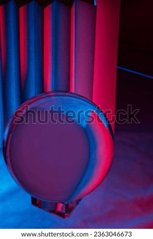 Abstract of Glass orb with blue and red paper