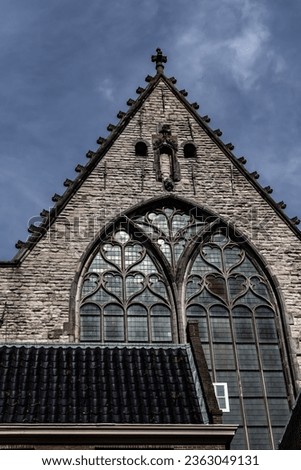 Amsterdam Old Church (Oude Kerk), oldest parish church, founded in 1213. Oude Kerk stands in Amsterdam De Wallen district on Old Church's Square (Oudekerksplein). Amsterdam, The Netherlands. Royalty-Free Stock Photo #2363049131