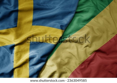 big waving national colorful flag of sweden and national flag of republic of the congo . macro