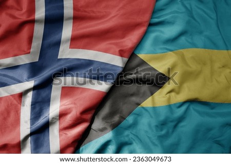big waving national colorful flag of norway and national flag of bahamas . macro