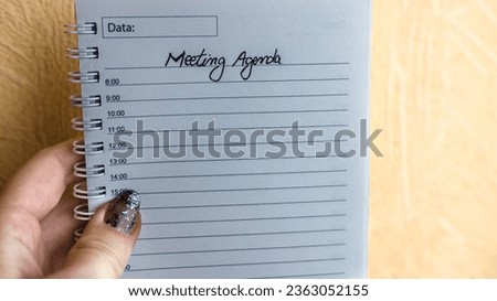 Text Meeting on personal agenda. Writing Meeting, hand holding office agenda. Bucharest, Romania, 2020.