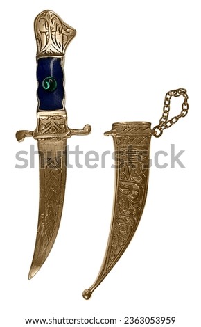 An intricate golden Dagger with green gem and scabbard Used for Defense Against an Enemy Royalty-Free Stock Photo #2363053959