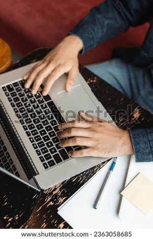 Closeup of copywriter hands typing on keyboard, using laptop working remotely in modern office, selective focus. Online business and education concept 