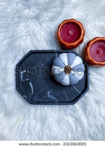 Coloured Pumpkins on Marble Tray with White Textured Background Flat Lay Photography
