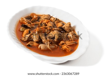 A white plate with pickled mussels, isolated on a white background. Pickled mussels are delicious sea mollusks in an exquisite sweet and sour sauce that awakens the senses.