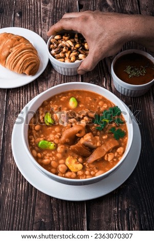 A traditional Peruvian shambar soup contains, wheat grains, broad beans, peas, chickpeas and dried beans, chicken, ham, veal, pig's ears and pig's tail. 