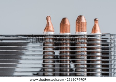 Macro photo of an aluminum cooling radiator. Plates of shiny metal in close-up. Heat sink tool with copper tubes. Royalty-Free Stock Photo #2363074909