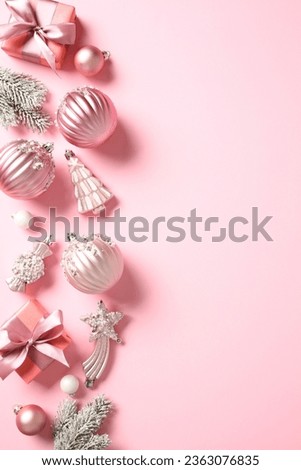 Stylish Christmas vertical banner template with gift boxes, balls, fir branches, decorations on pink background. Flat lay, top view.