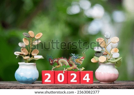 Jade stone symbol of good luck ,wealth and an old dragon on 2024 red wood on nature background.