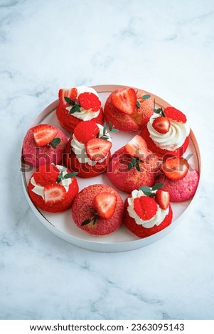 Shu cake. Pastry stuffed with creamy vanilla cream with a crispy top, garnished with strawberries.