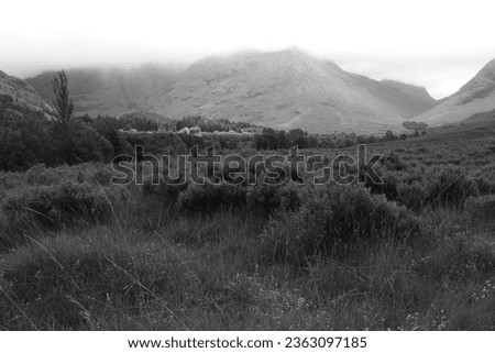 Scottish highland glen valley with dramatic light Royalty-Free Stock Photo #2363097185