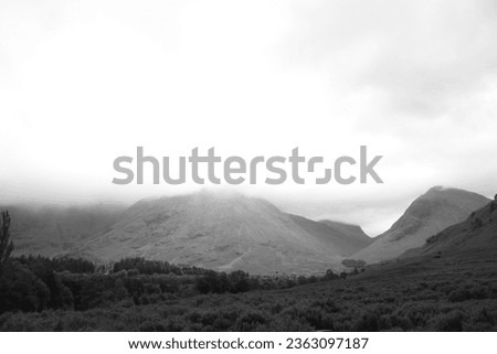 Scottish highland glen valley with dramatic light Royalty-Free Stock Photo #2363097187