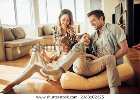 Young Caucasian family playing in the living room at home Royalty-Free Stock Photo #2363102325
