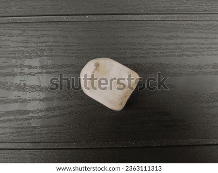 a rubber eraser that looks worn out on a black background
