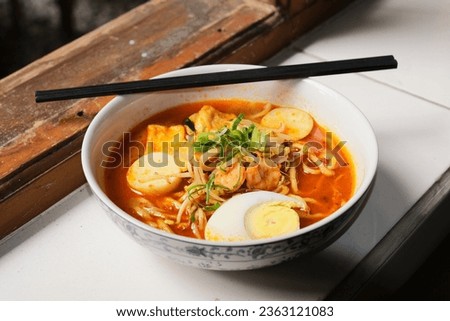 Laksa shrimp soup served on a bowl with chopstick Royalty-Free Stock Photo #2363121083
