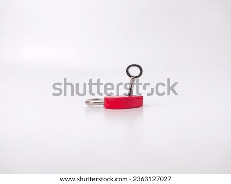Red love padlock with key on a white background