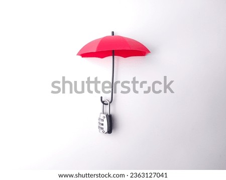 Silver padlock and red umbrella on a white background