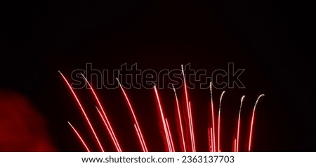 red streaking fireworks from the bottom of the photo