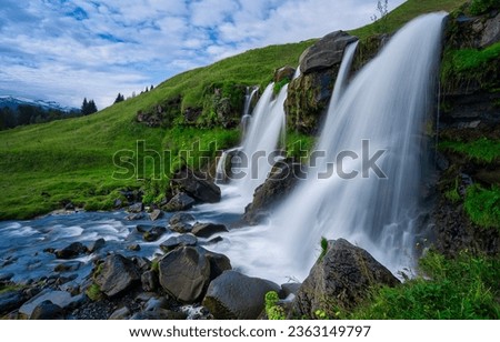Beautiful waterfalls in the plain. Mountain valley waterfall. Beautiful waterfall landscape. Waterfall in green valley