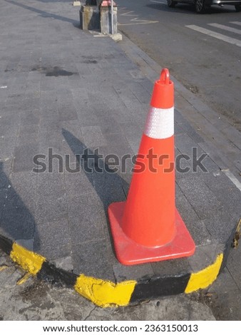 con on the way. Traffic cone on the road, close-up of a cone