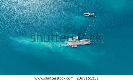 Aerial top view of Vessel engaged in dredging. Hopper dredger working at sea. Ship excavating material from a water  Royalty-Free Stock Photo #2363161151