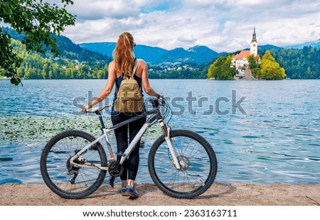 Woman tourist with mountain bike enjoying famous Bled lake- Travel, tour tourism, sport in Slovenia- Europe Royalty-Free Stock Photo #2363163711
