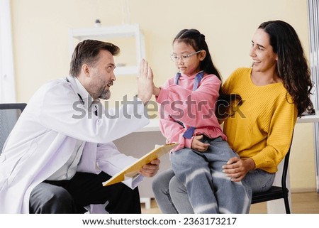 Mother with daughter meeting pediatrician doctor at the clinic for health check talking about mental problems. Royalty-Free Stock Photo #2363173217