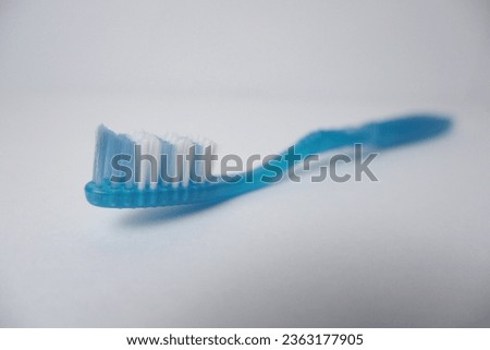 Photo of a toothbrush on a white background, taken with good angle, focus and lighting