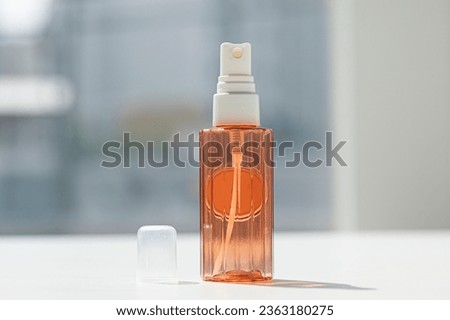 Empty spray bottle with cap isolated on white.