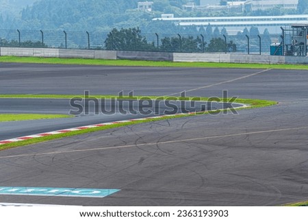A race track with tire marks and tire debris left behind Royalty-Free Stock Photo #2363193903